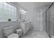 This bathroom features a glass-walled shower, a vanity with marble countertop, and a large window at 802 N Franklin St, Wake Forest, NC 27587
