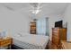 Cozy bedroom with hardwood floors, ceiling fan, built-in shelves, and a large window at 802 N Franklin St, Wake Forest, NC 27587