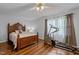 Bedroom with wooden floors, ceiling fan and elliptical machine at 802 N Franklin St, Wake Forest, NC 27587