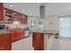 Well-lit kitchen boasts stainless steel appliances and a stylish island cooktop with granite counters at 802 N Franklin St, Wake Forest, NC 27587