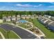 Aerial view of neighborhood amenities featuring a pool and playground surrounded by lush landscaping at 1585 Ivy Meadow Ln, Zebulon, NC 27597
