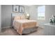 Charming bedroom with a white bed, pastel accents, and soft carpeting, bathed in natural light at 1585 Ivy Meadow Ln, Zebulon, NC 27597