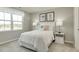 Charming bedroom with a large window and soft white linens at 1585 Ivy Meadow Ln, Zebulon, NC 27597