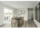 Bright dining area with a sliding glass door, wood table, and views of the backyard at 1585 Ivy Meadow Ln, Zebulon, NC 27597