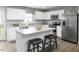 Bright kitchen with white cabinets, stainless steel appliances, granite countertops, and a center island at 1585 Ivy Meadow Ln, Zebulon, NC 27597