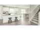 Eat-in kitchen featuring an island with barstool seating, white cabinets, and a view of the dining area and staircase at 1585 Ivy Meadow Ln, Zebulon, NC 27597
