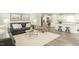 Cozy living room featuring a neutral color scheme, comfortable seating, and an adjacent kitchen with barstool seating at 1585 Ivy Meadow Ln, Zebulon, NC 27597