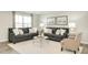Living room with lots of seating, neutral walls, and large windows for natural light at 1585 Ivy Meadow Ln, Zebulon, NC 27597
