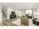 Inviting living room featuring modern gray sofas, neutral walls, and light wood-look flooring at 1585 Ivy Meadow Ln, Zebulon, NC 27597