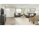 Bright living room featuring stylish sofas, neutral decor, and an open doorway at 1585 Ivy Meadow Ln, Zebulon, NC 27597