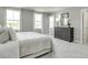 Bright main bedroom with white bedding, soft carpet, and a balcony entrance at 1585 Ivy Meadow Ln, Zebulon, NC 27597