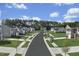 Scenic street view showcasing beautiful homes, sidewalks, and lush landscaping in a well-planned community at 1585 Ivy Meadow Ln, Zebulon, NC 27597