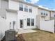 Backyard features a small patio and lawn with a new home construction backdrop at 18 Clementine Street St # 207, Angier, NC 27501