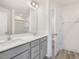 Bathroom with dual sinks, grey vanity, and a large mirror, providing a modern and functional space at 18 Clementine Street St # 207, Angier, NC 27501