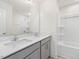 Bright bathroom featuring a double sink vanity with white countertop and an all white tub-shower at 18 Clementine Street St # 207, Angier, NC 27501