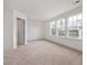 Spacious carpeted bedroom with three large windows at 18 Clementine Street St # 207, Angier, NC 27501