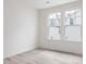 Bright bedroom features wood floors and large windows that provide natural light at 18 Clementine Street St # 207, Angier, NC 27501