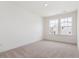 Light-filled bedroom featuring neutral carpet and a pair of windows offering natural light at 18 Clementine Street St # 207, Angier, NC 27501