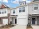 Charming townhome showcasing a light and airy exterior with a one-car garage and manicured front yard at 18 Clementine Street St # 207, Angier, NC 27501