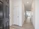 Bright hallway with light wood floors, freshly painted walls, and convenient access to various rooms at 18 Clementine Street St # 207, Angier, NC 27501