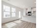 Open kitchen and dining area with white cabinets and stainless steel appliances at 18 Clementine Street St # 207, Angier, NC 27501