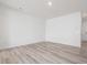 Bright living room features light wood floors, crisp white walls, and recessed lighting at 18 Clementine Street St # 207, Angier, NC 27501