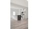 Open-concept living space featuring light wood floors, a kitchen island, and modern appliances at 18 Clementine Street St # 207, Angier, NC 27501
