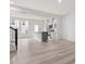 Open-concept living space featuring light wood floors, a kitchen island, and modern appliances at 18 Clementine Street St # 207, Angier, NC 27501