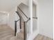 Staircase with carpeted stairs and white and brown wood railing at 18 Clementine Street St # 207, Angier, NC 27501
