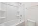 Clean tub-shower combo with a white surround, equipped with shelves and chrome fixtures at 18 Clementine Street St # 207, Angier, NC 27501