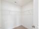 Clean, carpeted walk-in closet featuring white wire shelving for organized storage at 18 Clementine Street St # 207, Angier, NC 27501