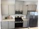 Modern kitchen featuring stainless steel appliances, gas range and modern gray cabinets at 2034 Fishamble St, Fuquay Varina, NC 27526