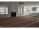 Open living room with a fireplace and large windows, seamlessly connecting to the kitchen area at 846 Cabin Creek Crk, Pittsboro, NC 27312