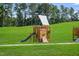 Wooden playground structure with slide and climbing features at 612 Cassa Clubhouse Way # 65, Knightdale, NC 27545