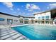 Relaxing pool area with lounge chairs and a modern clubhouse at 612 Cassa Clubhouse Way # 65, Knightdale, NC 27545