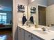 Updated bathroom featuring double sinks and a large mirror, steps away from the main bedroom at 1001 Hillsborough St # 304, Raleigh, NC 27603