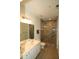 Bathroom featuring double sink, toilet, and glass enclosed shower with a tiled surround at 1001 Hillsborough St # 304, Raleigh, NC 27603