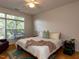 A cozy bedroom with a large window, hardwood floors, and plenty of natural light at 1001 Hillsborough St # 304, Raleigh, NC 27603
