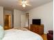 Bright bedroom has wood floors, a dresser, a TV, and ensuite access to a tiled bathroom and closet at 1001 Hillsborough St # 304, Raleigh, NC 27603