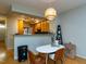 Charming dining area with a modern light fixture next to the breakfast bar at 1001 Hillsborough St # 304, Raleigh, NC 27603