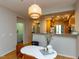 Dining area with a modern light fixture, open to kitchen and laundry area at 1001 Hillsborough St # 304, Raleigh, NC 27603
