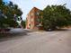 Exterior view of a red brick apartment complex with visible parking and tree lined landscape at 1001 Hillsborough St # 304, Raleigh, NC 27603