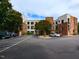 Low-rise brick condo building exterior with a neatly maintained parking area and attractive landscaping at 1001 Hillsborough St # 304, Raleigh, NC 27603