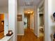 Hallway with hardwood floors leading to a full bathroom and other rooms at 1001 Hillsborough St # 304, Raleigh, NC 27603