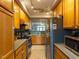 Kitchen with stainless steel appliances, oak cabinets, and breakfast bar at 1001 Hillsborough St # 304, Raleigh, NC 27603