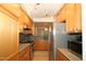 Spacious kitchen featuring stainless steel appliances, custom backsplash, and eat-in dining area at 1001 Hillsborough St # 304, Raleigh, NC 27603