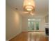 Bright living room featuring hardwood floors, fireplace, and access to the outside through French doors at 1001 Hillsborough St # 304, Raleigh, NC 27603