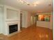 Bright living room with hardwood floors and fireplace; view to kitchen at 1001 Hillsborough St # 304, Raleigh, NC 27603