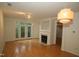 Open living room with hardwood floors, modern lighting, fireplace, and access to private balcony at 1001 Hillsborough St # 304, Raleigh, NC 27603