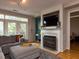 Cozy living room featuring a fireplace, TV, and balcony access with natural light at 1001 Hillsborough St # 304, Raleigh, NC 27603